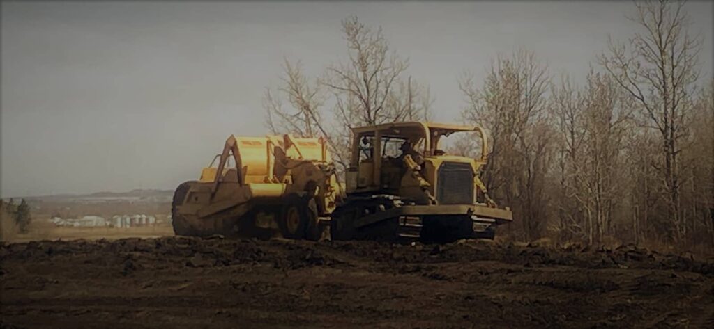 Cat and scraper construction equipment