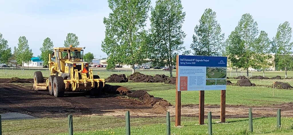 Construction grader levelling ground