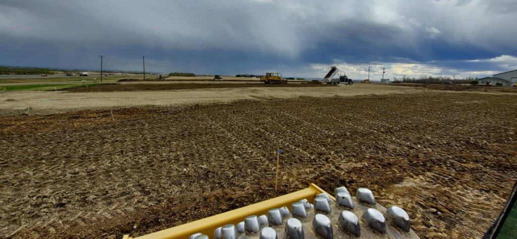 Heavy construction equipment spreading material