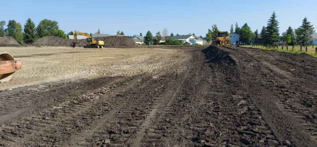 Heavy construction equipment working on ball diamond